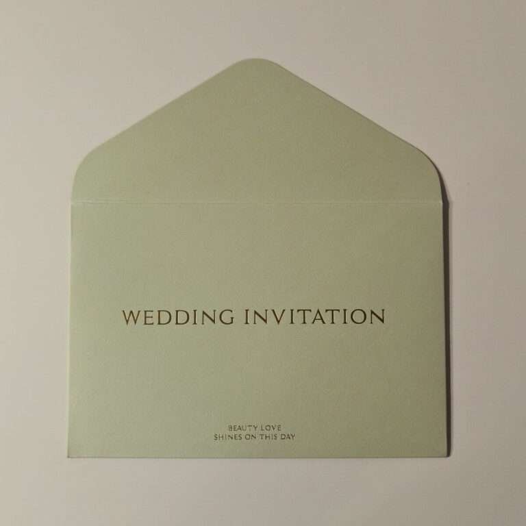 Front view of a Classic Plain Wine Red Wedding Invitation Envelope with gold embossed lettering and decorative emblem from Xamiya Wedding.