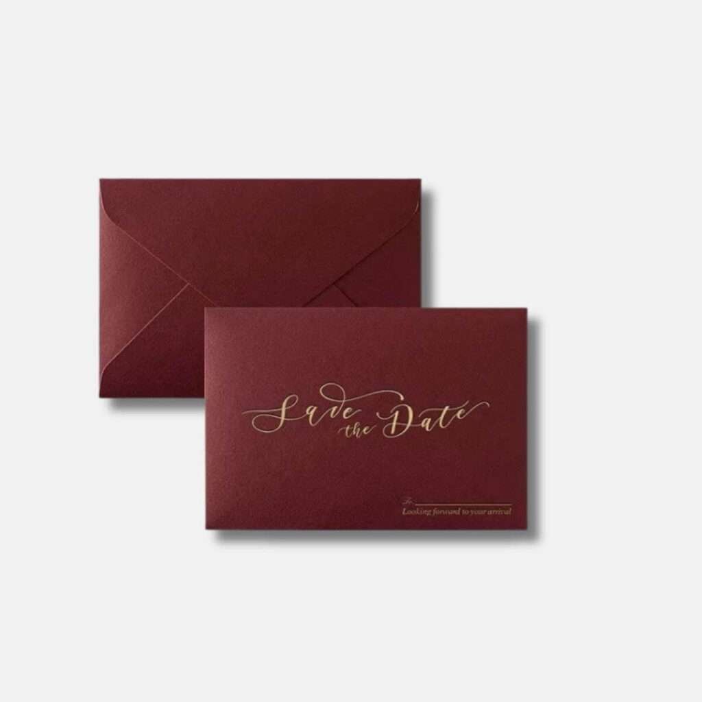 Elegant 'Save the Date' premium invitation envelope in wine red, with customizable guest name field in the bottom right corner, part of the Xamiya Wedding premium collection.